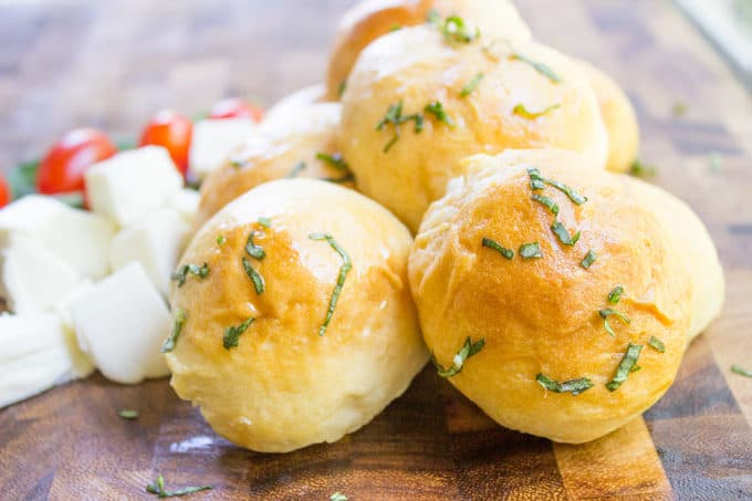 Caprese Pizza Bombs are a quick, fun treat or appetizer with fresh mozzarella, basil and cherry tomatoes. Plus the stretchy cheese factor is amazing.