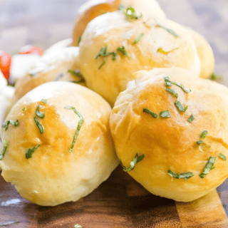 cheesy pie balls stacked on one another on a cutting board