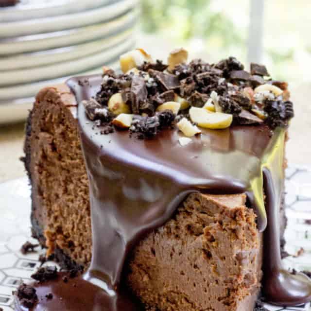 Rich Chocolate Hazelnut Cheesecake made with Chocmeister Milk Chocolatey Hazelnut Spread, a chocolate cookie crust and a thick, glossy chocolate ganache.