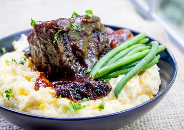 cooked beef and BBQ sauce in bowl with veggies