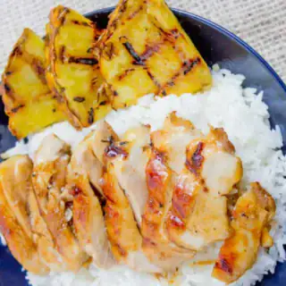 chicken with rice and pineapple on a plate