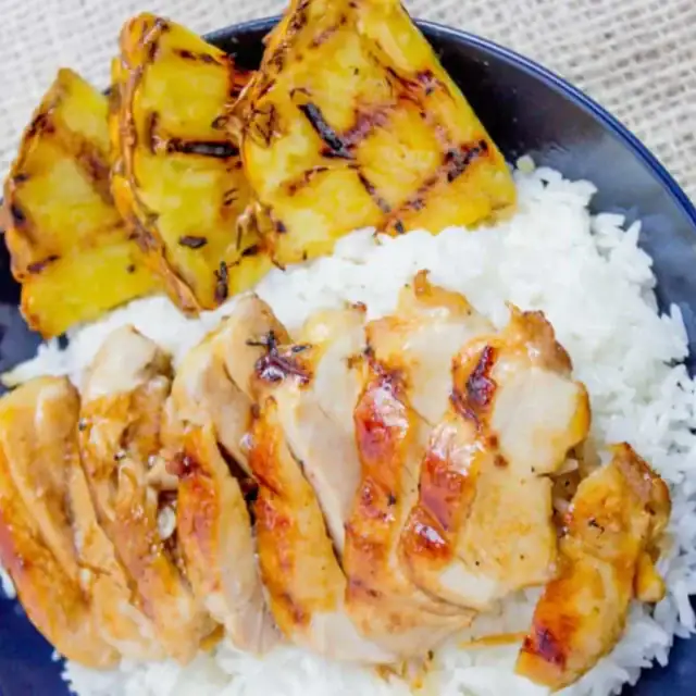 chicken with rice and pineapple on a plate