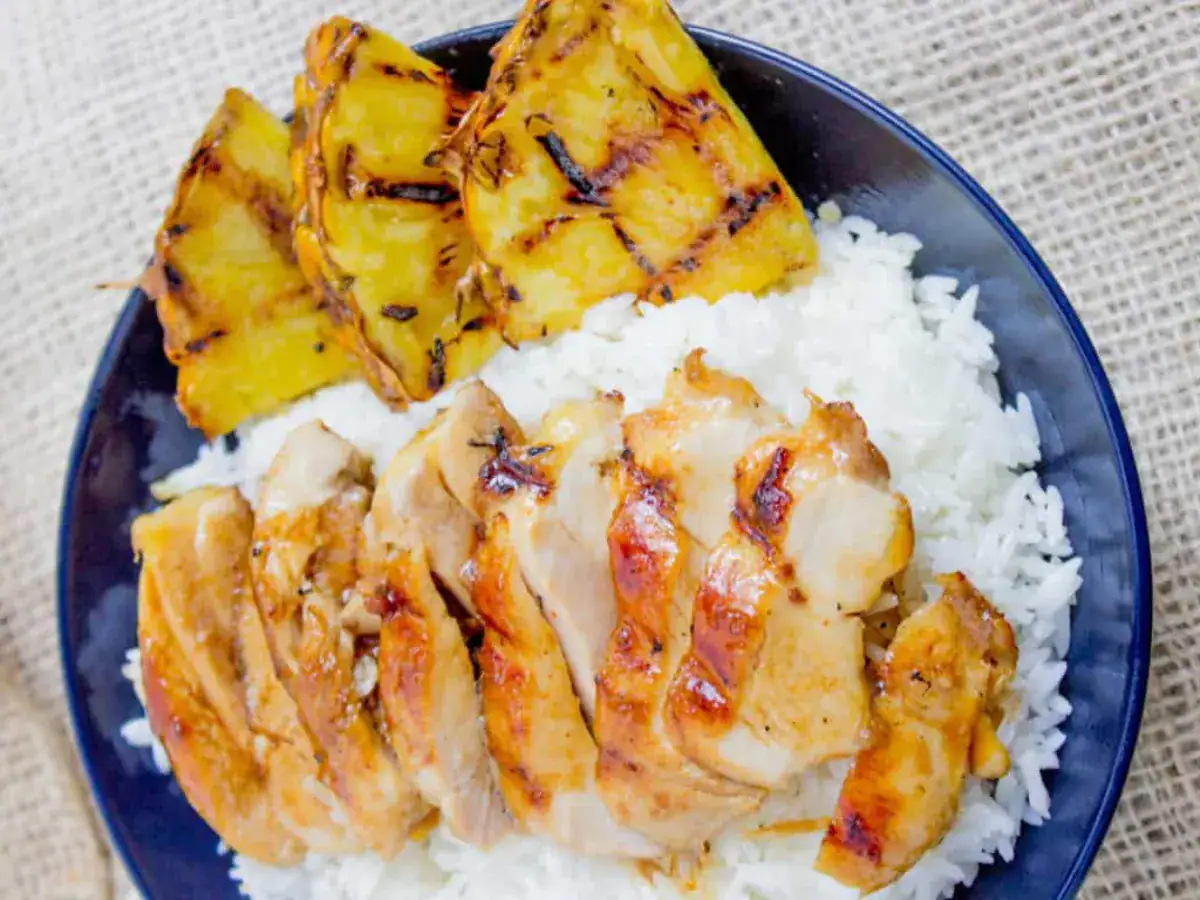 chicken with rice and pineapple on a plate