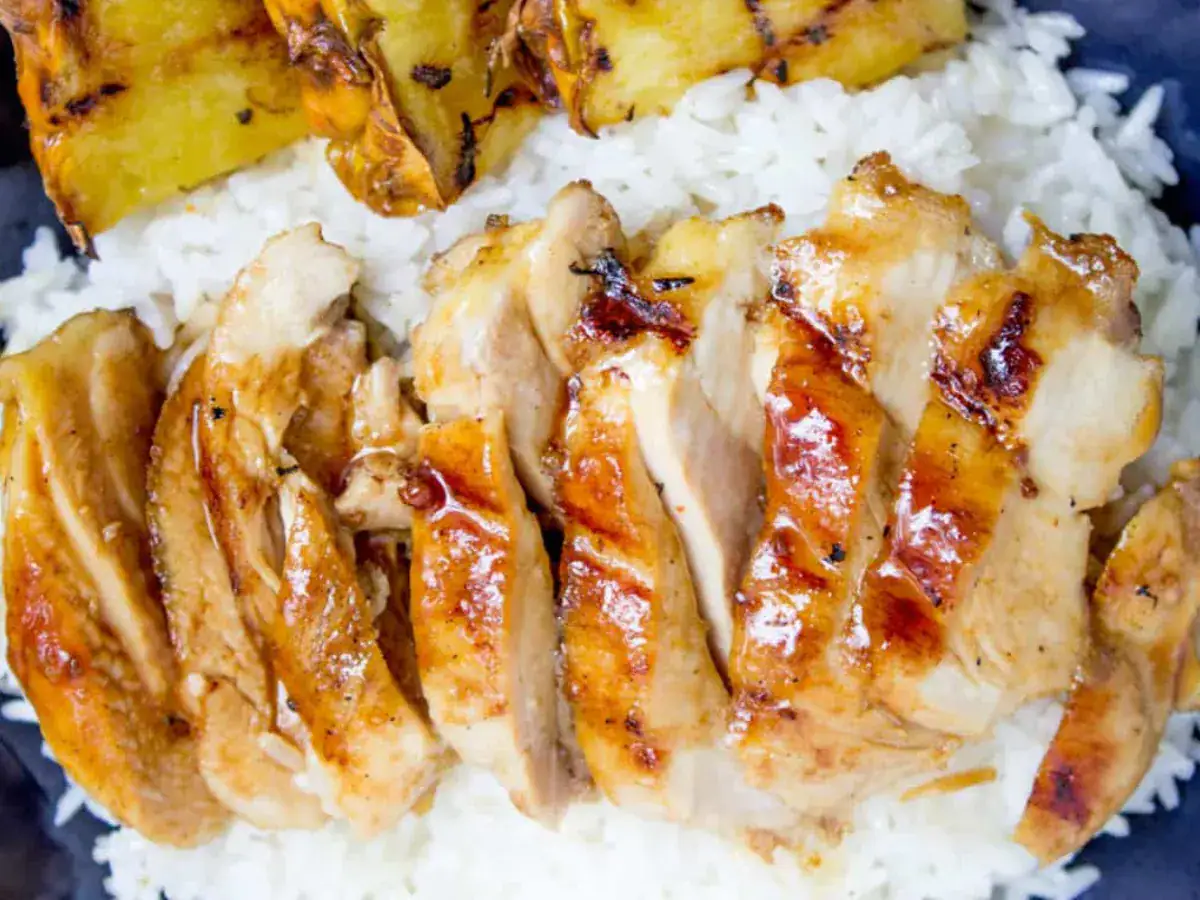 close up of chicken on rice with grilled pineapple 
