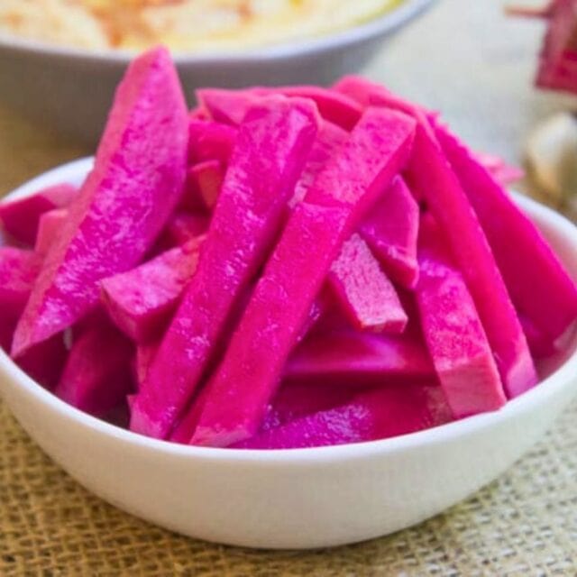small white bowl of pickled turnip slices