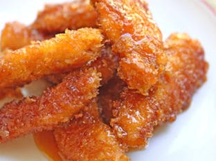 Chicken Fire Poppers are panko crusted, skillet fried then dipped in the most glorious honey-brown sugar hot sauce you've ever tasted and baked until they are bites of crunchy, sticky, sweet, spicy perfection!