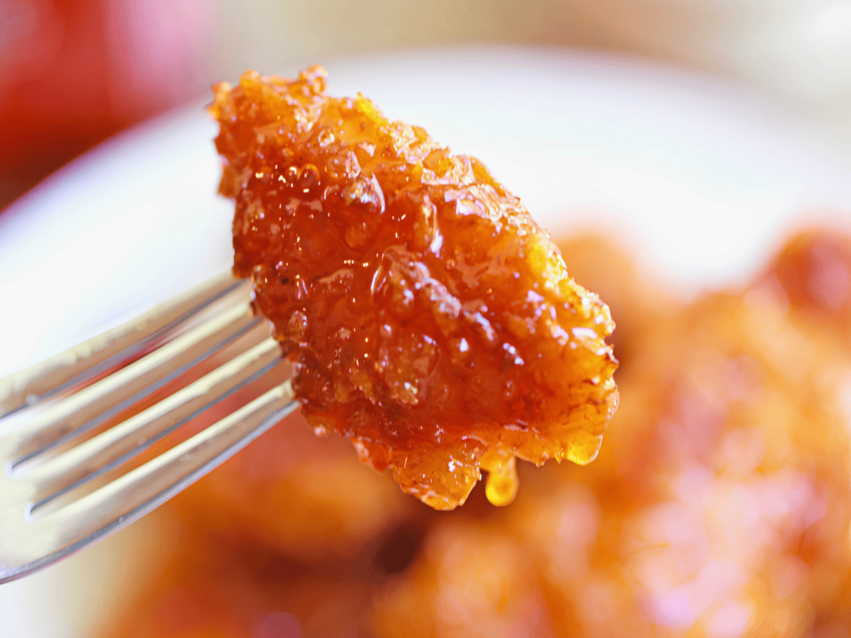 piece of sticky crispy chicken on a fork