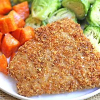 fish on a white plate with brussels sprouts and sweet potato