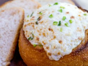Artichoke Cheese Dip takes five minutes of prep and full of artichokes, Parmesan and cream cheese that is baked in a bread bowl for the perfect appetizer! dinnerthendessert.com