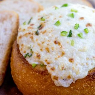 Artichoke Cheese Dip takes five minutes of prep and full of artichokes, Parmesan and cream cheese that is baked in a bread bowl for the perfect appetizer! dinnerthendessert.com