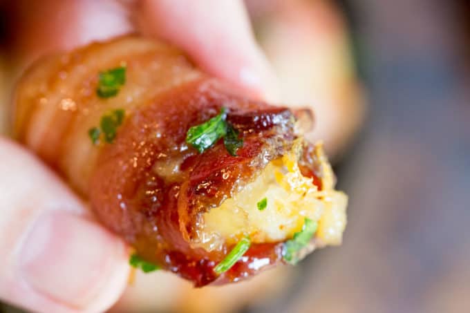 Bacon Wrapped Tater Tot Bombs are an easy appetizer of tater tots and sharp cheddar cheese wrapped in thick cut bacon, rolled in brown sugar and baked.