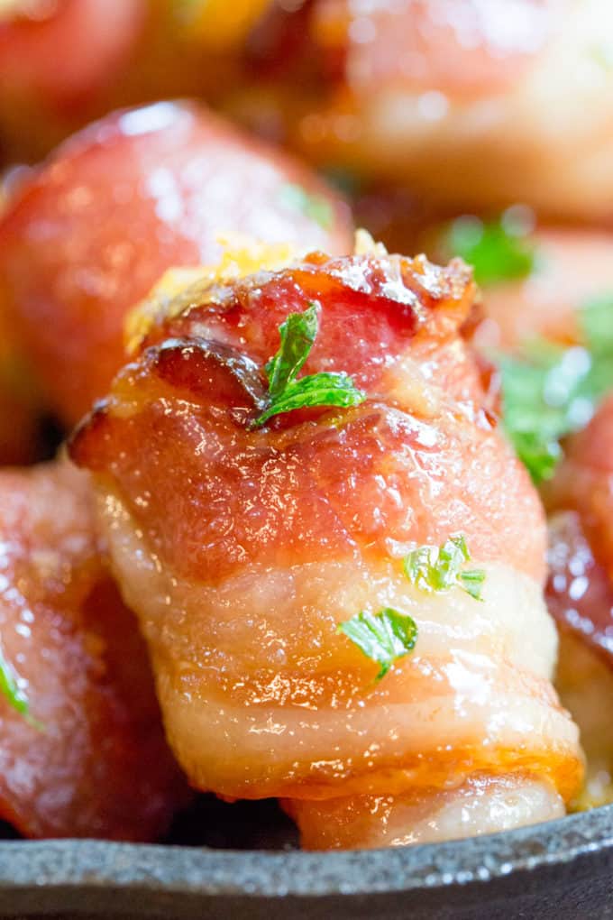 Bacon Wrapped Tater Tot Bombs are an easy appetizer of tater tots and sharp cheddar cheese wrapped in thick cut bacon, rolled in brown sugar and baked.