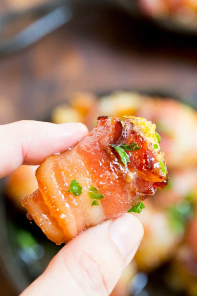 Bacon Wrapped Tater Tot Bombs are an easy appetizer of tater tots and sharp cheddar cheese wrapped in thick cut bacon, rolled in brown sugar and baked.