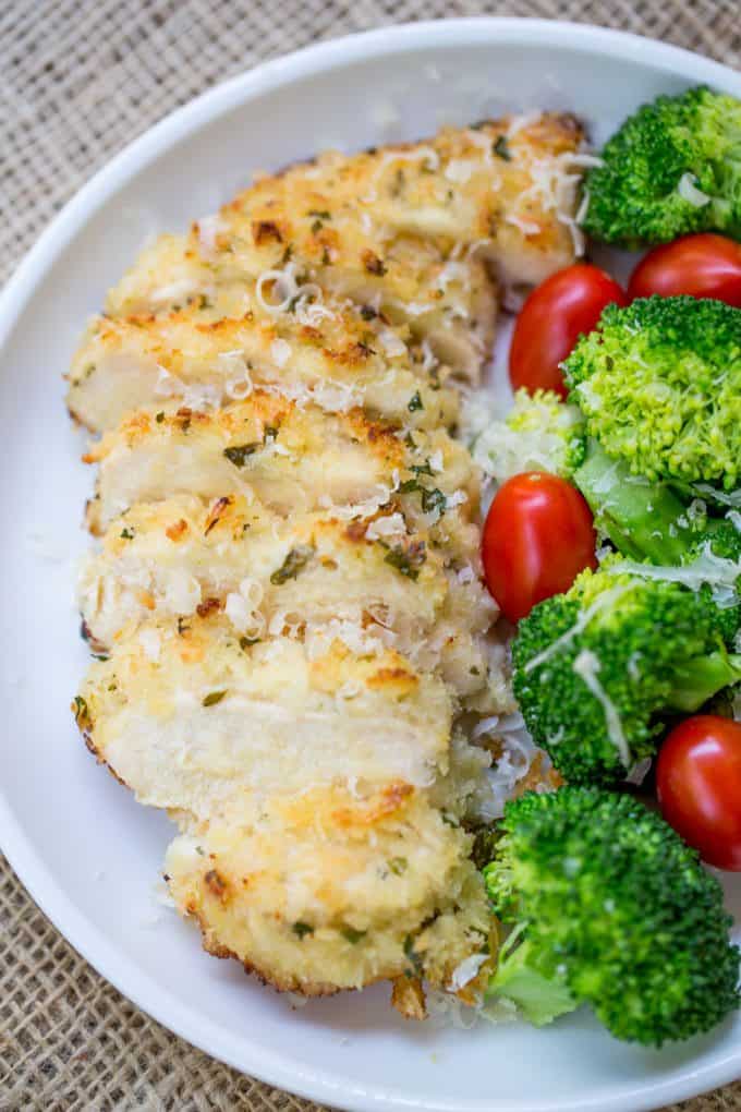 baked breaded chicken dish with lemon and parmesan served with broccoli