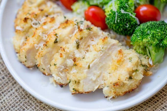 baked breaded chicken served with cherry tomatoes 
