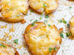 Parmesan Garlic Crash Hot Potatoes are crispy, creamy, cheesy and garlicky. Made in one pan, there is no boiling necessary and they make the perfect holiday side dish.