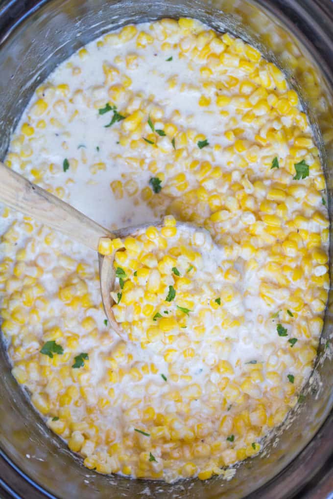 Slow Cooker Creamed Corn with serving spoon
