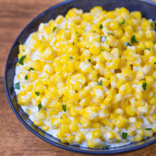 silky golden kernels in a blue bowl with green garnish