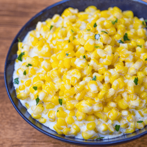 silky golden kernels in a blue bowl with green garnish