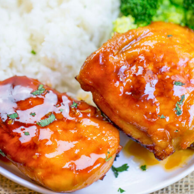 Baked chicken with sauce plated with rice and broccoli