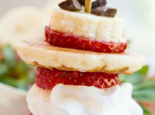 Banana Split Pancake Bites are an easy brunch dish for a party or for your little ones with homemade silver dollar pancakes, Nutella, bananas, strawberries, whipped cream and chocolate chips.