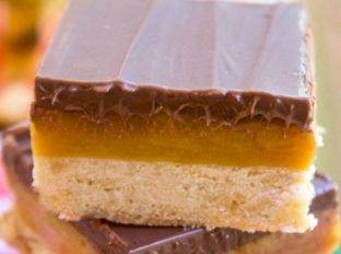 Homemade Twix Bars with a classic shortbread crust, gooey caramel filling and a sweet milk chocolate topping. A perfect homemade candy bar copycat.