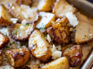 Parmesan Pesto Roasted Potatoes are ready for roasting in minutes with red potatoes, basil pesto, olive oil and Parmesan Cheese.