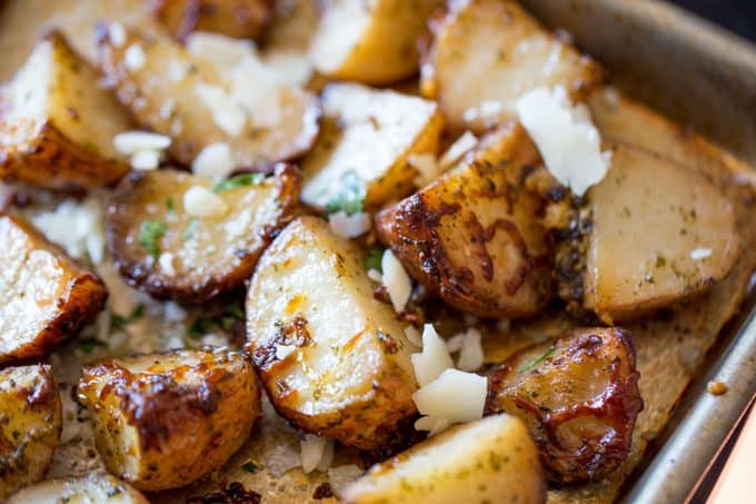 Parmesan Pesto Roasted Potatoes are ready for roasting in minutes with red potatoes, basil pesto, olive oil and Parmesan Cheese.