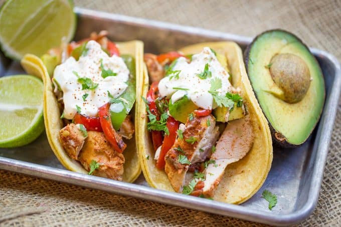 crockpot chicken fajitas served with limes and avocado