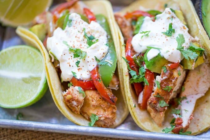 slow cooker chicken fajitas in tortillas served with lime