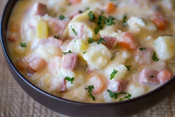 Slow Cooker Ham and Potato Soup that's creamy, full of vegetables and chunks of ham, finished off with milk and sour cream for a easy and delicious hearty soup.