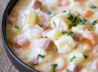 Slow Cooker Ham and Potato Soup that's creamy, full of vegetables and chunks of ham, finished off with milk and sour cream for a easy and delicious hearty soup.