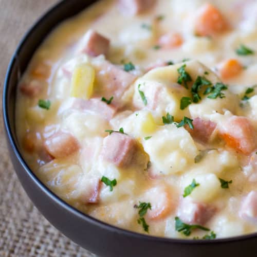 Slow Cooker Ham and Potato Soup that's creamy, full of vegetables and chunks of ham, finished off with milk and sour cream for a easy and delicious hearty soup.