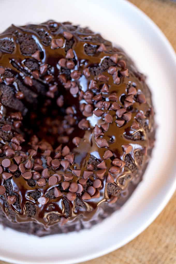 Triple Chocolate Bundt Cake with the richest chocolate cake made from scratch and covered in a dark chocolate ganache and extra chocolate chips.