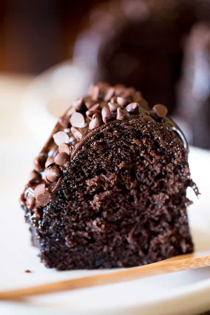 Triple Chocolate Bundt Cake with the richest chocolate cake made from scratch and covered in a dark chocolate ganache and extra chocolate chips.