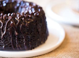 Triple Chocolate Bundt Cake with the richest chocolate cake made from scratch and covered in a dark chocolate ganache and extra chocolate chips.