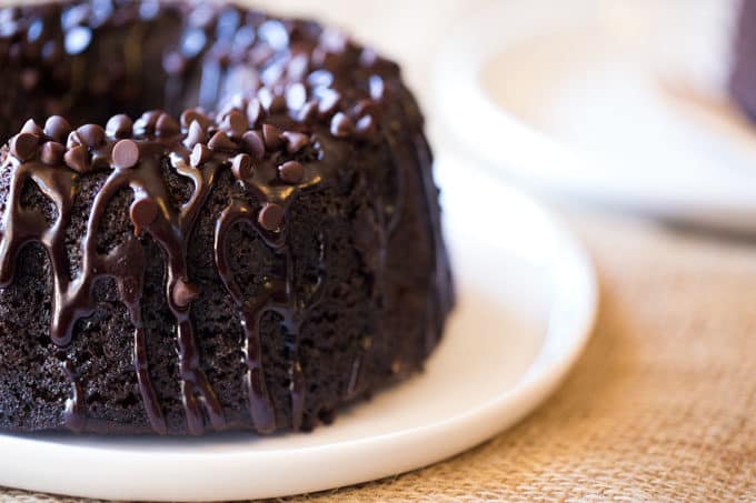 Triple Chocolate Bundt Cake with the richest chocolate cake made from scratch and covered in a dark chocolate ganache and extra chocolate chips.