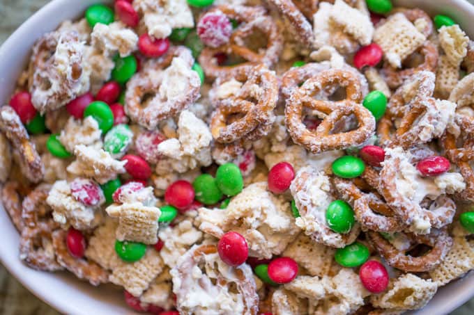 Christmas White Chocolate Trash Snack Mix with pretzels, cereal, peanuts and chocolate coated candies all tossed together with a generous coating of white chocolate.