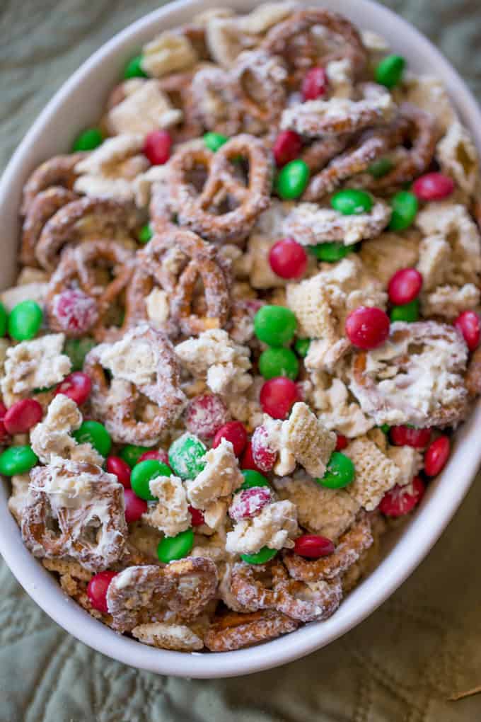 Christmas White Chocolate Trash Snack Mix with pretzels, cereal, peanuts and chocolate coated candies all tossed together with a generous coating of white chocolate.