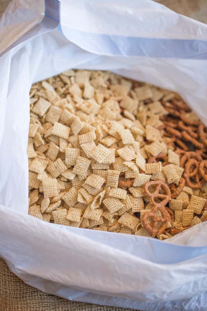 Christmas White Chocolate Trash Snack Mix with pretzels, cereal, peanuts and chocolate coated candies all tossed together with a generous coating of white chocolate.