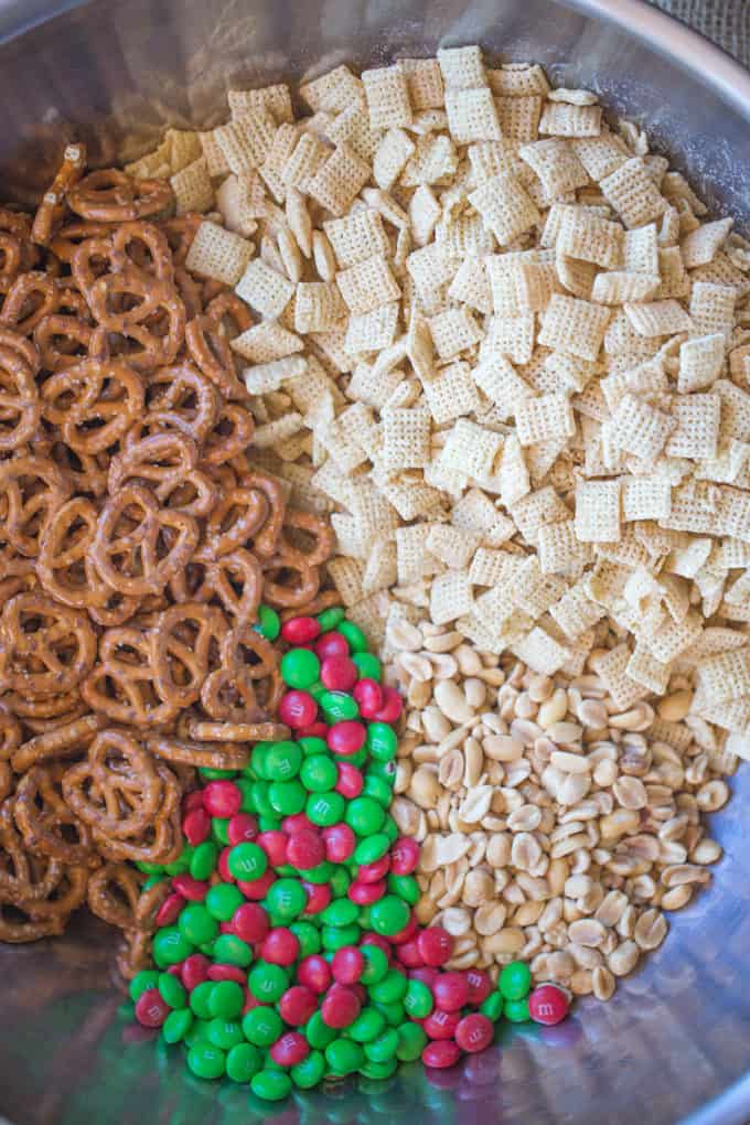 Christmas White Chocolate Trash Snack Mix with pretzels, cereal, peanuts and chocolate coated candies all tossed together with a generous coating of white chocolate.