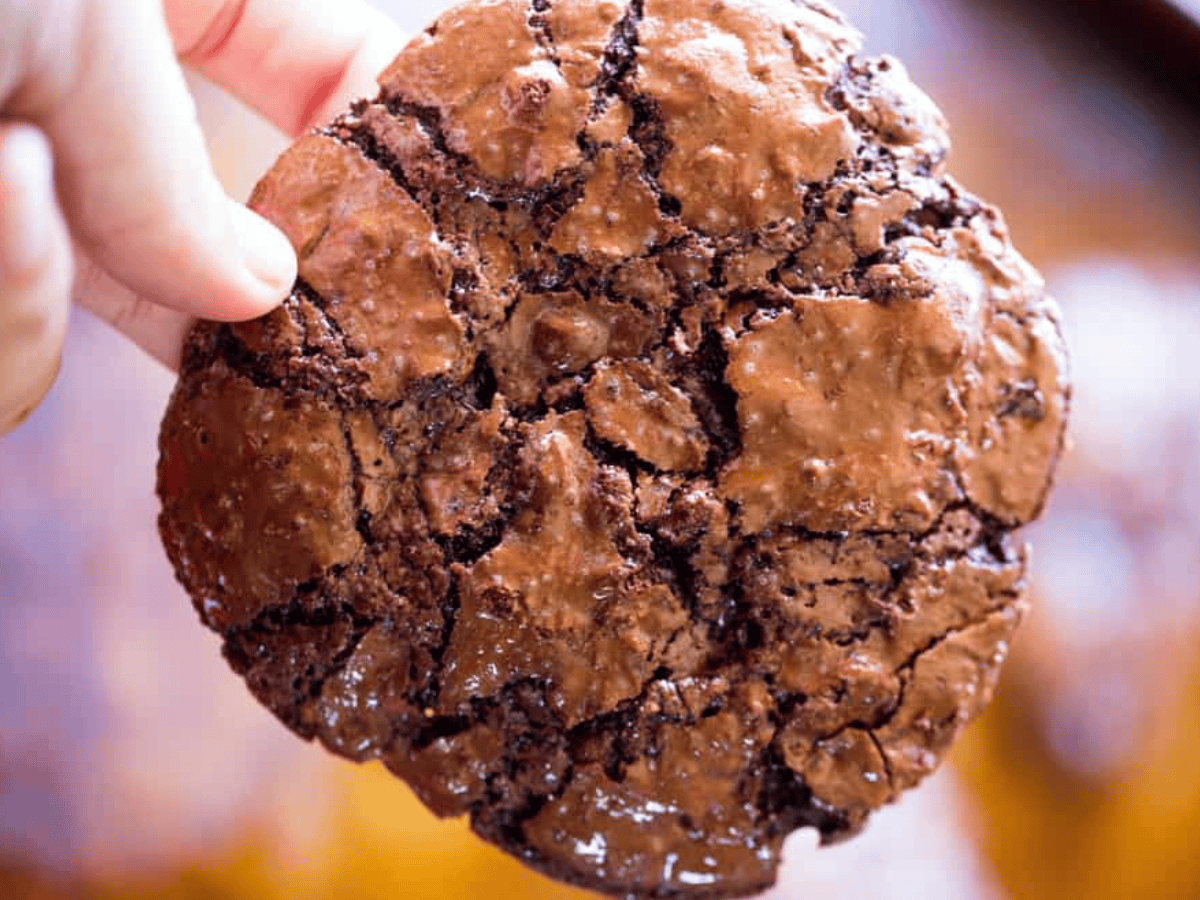 Hand holding cookie to show top