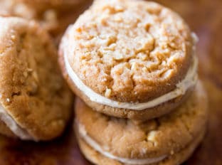 Peanut Butter Do-si-dos Cookie Sandwiches are a Girl Scouts favorite made with peanut butter and oatmeal are sandwiched together with a fluffy soft peanut butter buttercream filling.