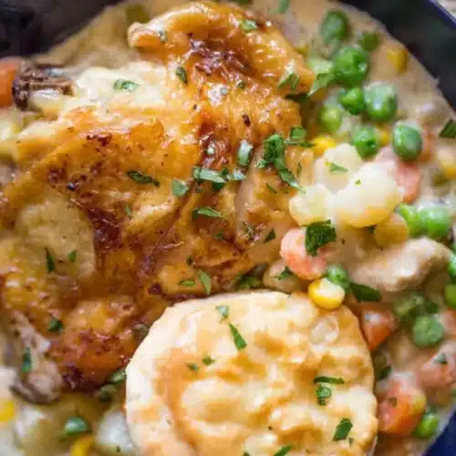 bowl of chicken and veggies with a biscuit