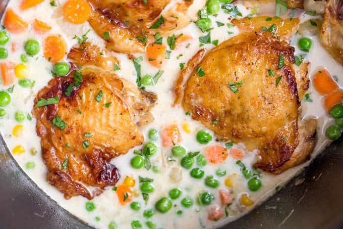 Slow Cooker Crispy Chicken Pot Pie with crispy chicken thighs and all your favorite pot pie vegetables cooked together to make a thick and creamy side dish to the chicken.