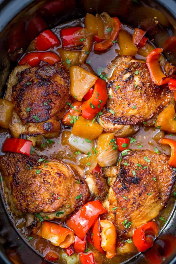 Slow Cooker Hawaiian Pineapple Chicken with crispy chicken thighs, fresh pineapple chunks, onions and bell pepper takes 15 minutes of prep and makes the perfect meal to come home to after a long workday!