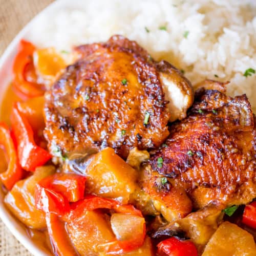 Slow Cooker Hawaiian Pineapple Chicken with crispy chicken thighs, fresh pineapple chunks, onions and bell pepper takes 15 minutes of prep and makes the perfect meal to come home to after a long workday!