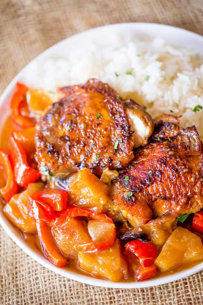 Slow Cooker Hawaiian Pineapple Chicken with crispy chicken thighs, fresh pineapple chunks, onions and bell pepper takes 15 minutes of prep and makes the perfect meal to come home to after a long workday!