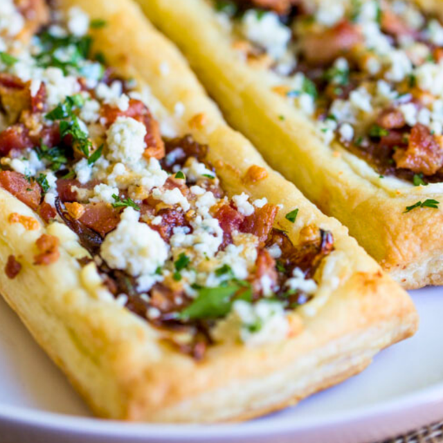 crispy pork, dairy spread, and greens on a baked pastries