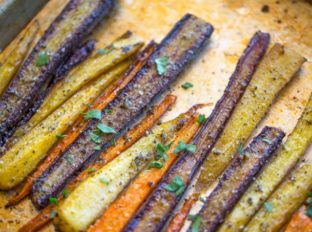 Garlic Butter Roasted Carrots with a touch of canola oil, cracked black pepper and Kosher salt makes the perfect side dish for a weeknight meal or a holiday crowd.